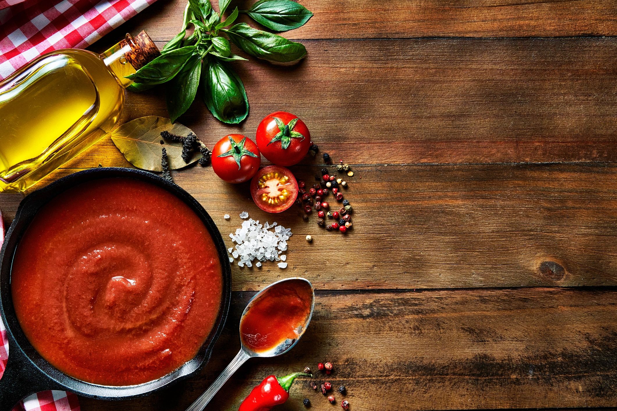 Overhead ingredients for tomato pasta with basil and garlic